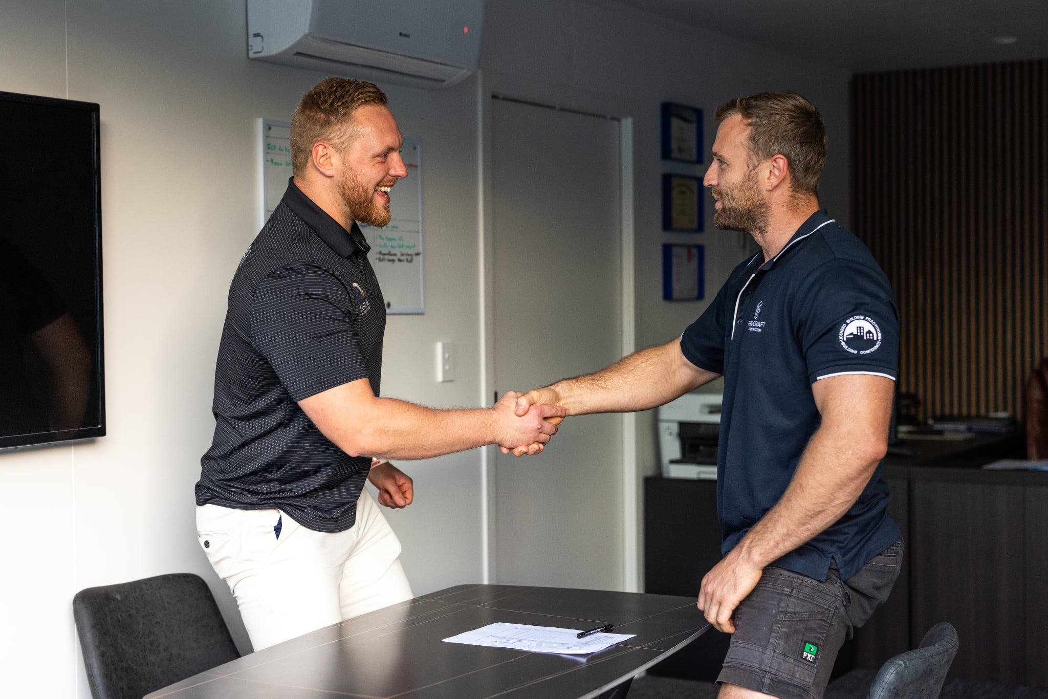Joe Muller of Elite AI Automations (left) shaking hands with a client